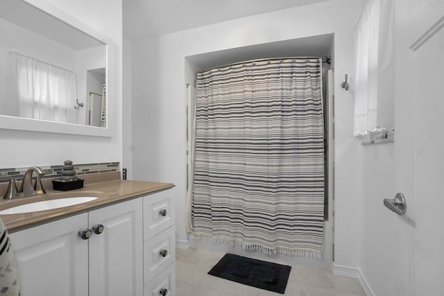 bathroom featuring a shower with curtain, tile patterned flooring, and vanity