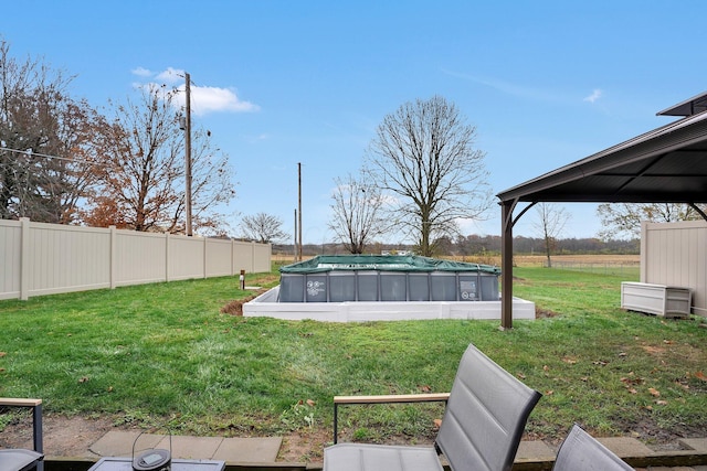 view of yard with a gazebo and a covered pool