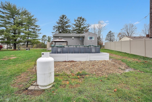 back of house with a gazebo and a yard