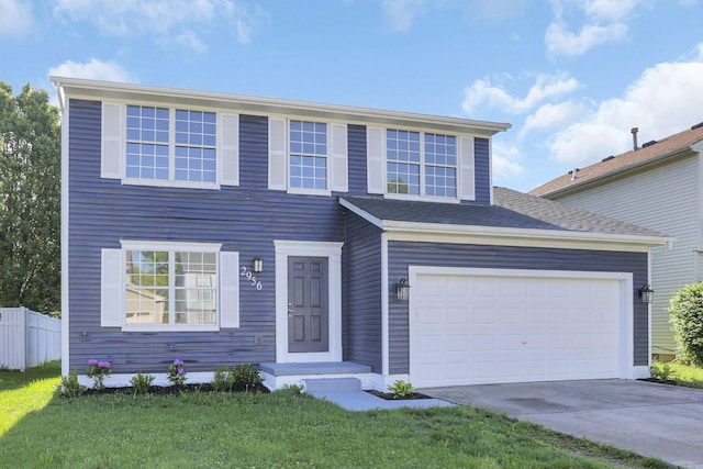 view of front of house with a front yard and a garage