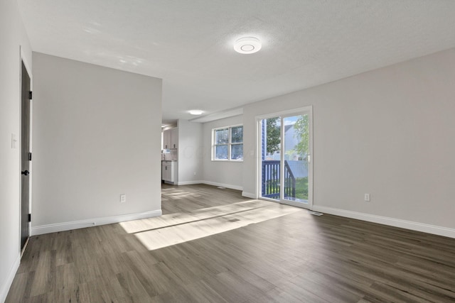 spare room with wood-type flooring and a textured ceiling