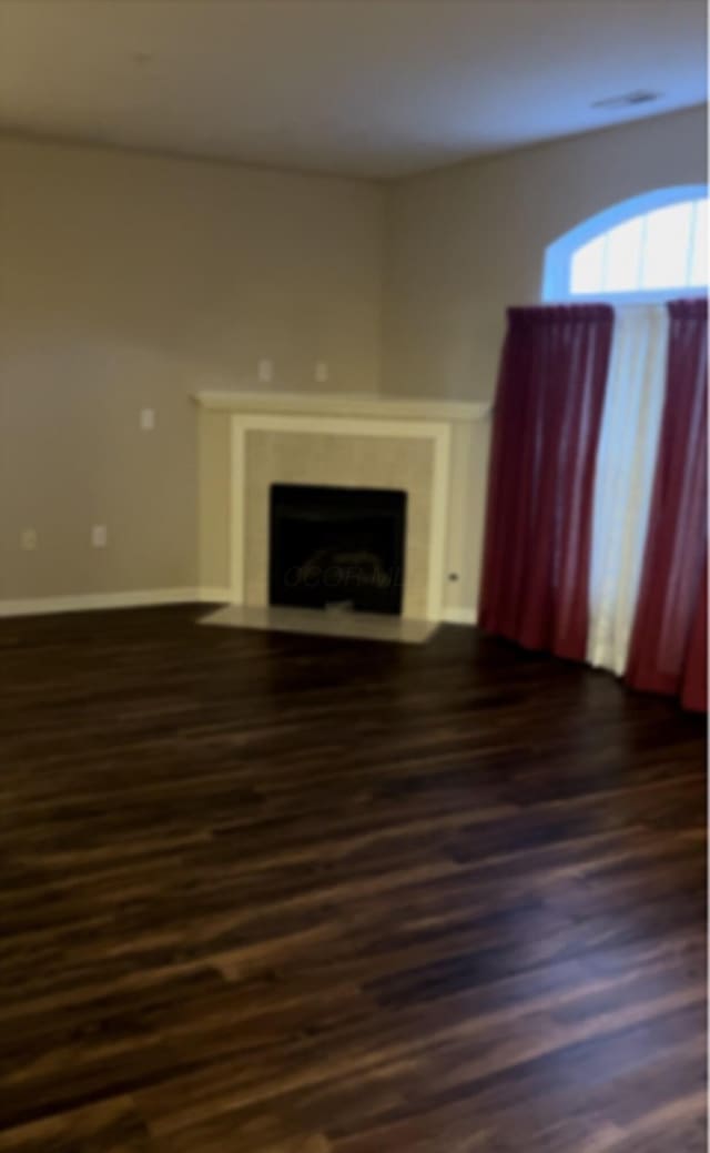 unfurnished living room featuring dark hardwood / wood-style flooring