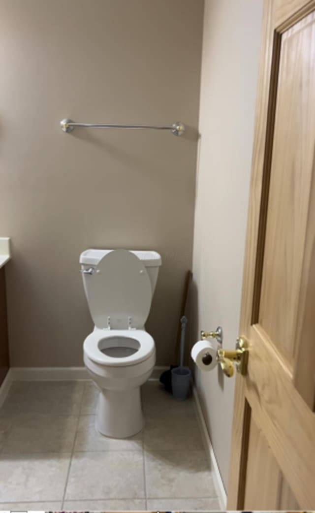 bathroom with toilet and tile patterned floors