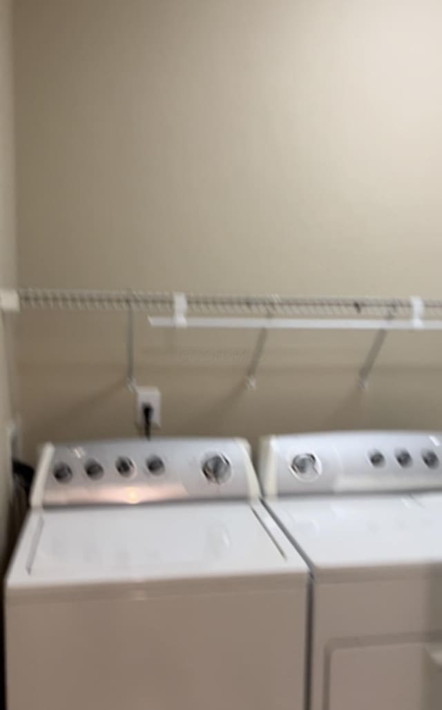 clothes washing area featuring washing machine and clothes dryer