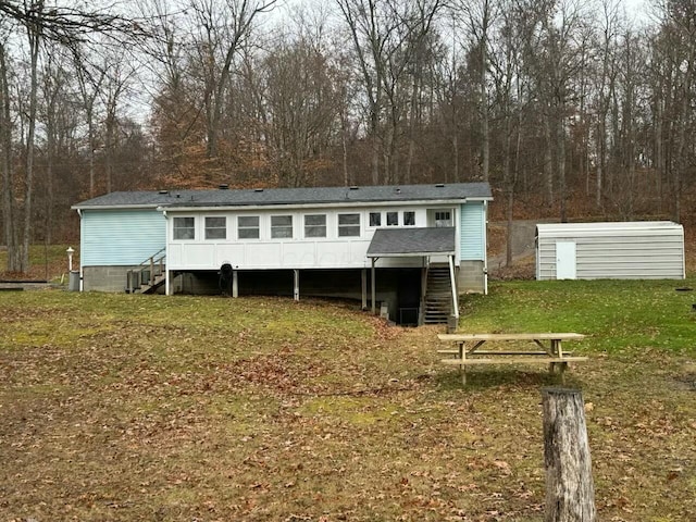 rear view of property with a yard