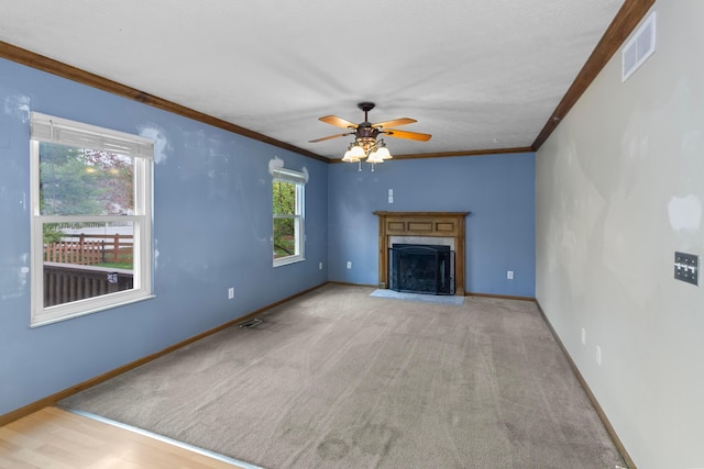 unfurnished living room with ceiling fan, light colored carpet, and ornamental molding