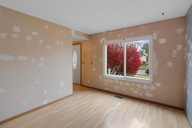 empty room with light hardwood / wood-style flooring