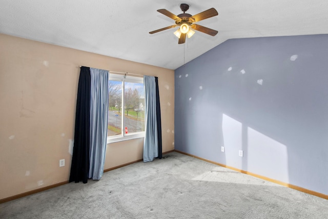 empty room with ceiling fan, light carpet, and lofted ceiling