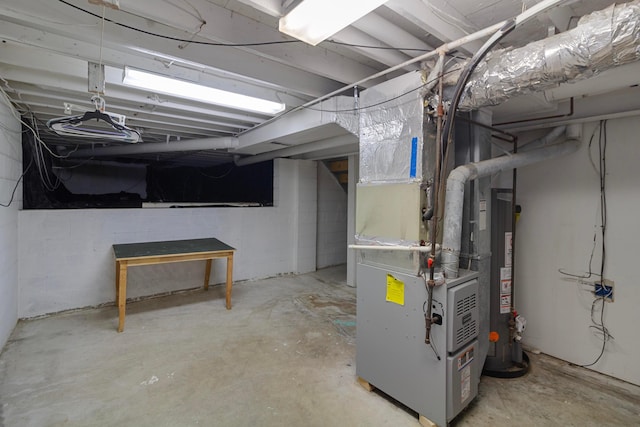 basement featuring heating unit and water heater