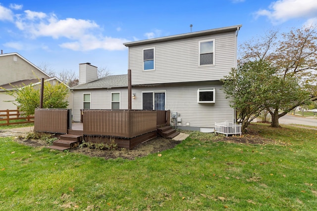 back of property with a yard and a wooden deck