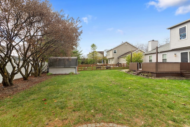 view of yard featuring a shed and a wooden deck