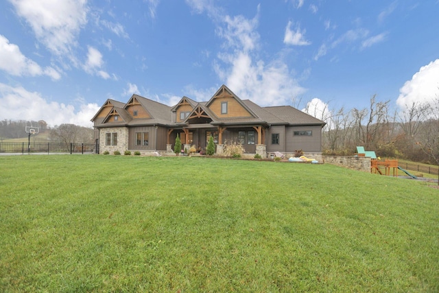 craftsman inspired home featuring a playground and a front lawn