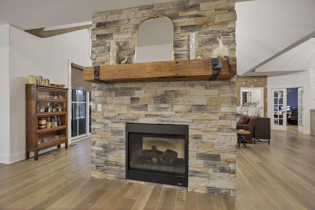 interior details with a fireplace, french doors, and hardwood / wood-style flooring