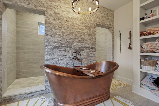 bathroom with built in features and a tub