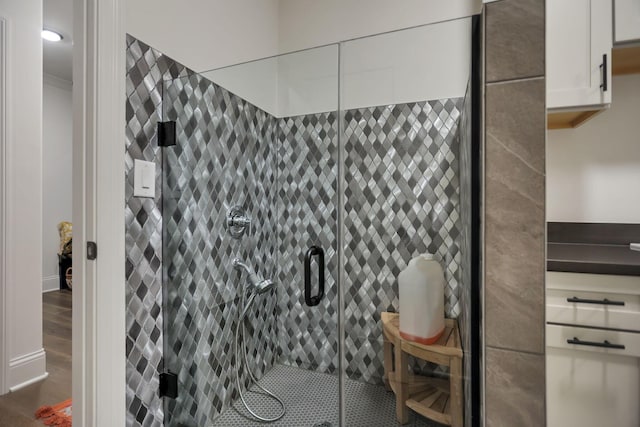 bathroom featuring hardwood / wood-style flooring and an enclosed shower