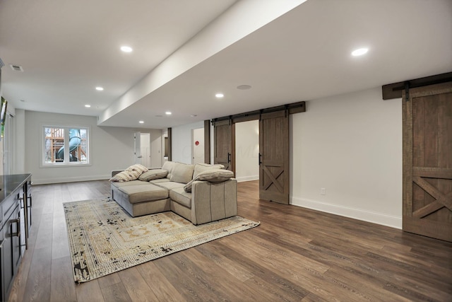 living room featuring a barn door and hardwood / wood-style floors