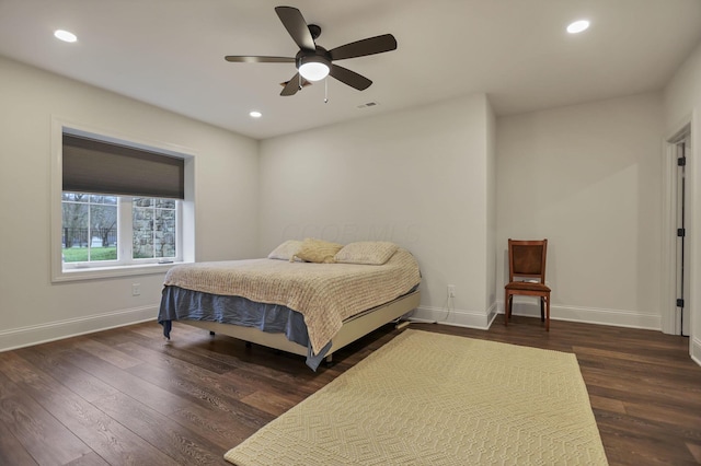 bedroom with ceiling fan and dark wood-type flooring