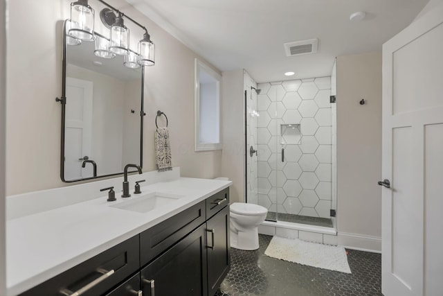 bathroom with toilet, vanity, tile patterned floors, and a shower with door