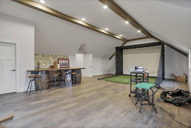 playroom with vaulted ceiling with beams, light hardwood / wood-style floors, and golf simulator