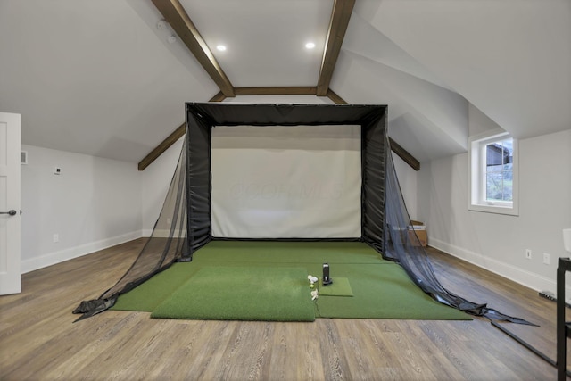 game room featuring vaulted ceiling with beams, golf simulator, and wood-type flooring