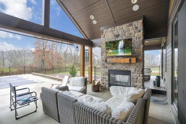 view of patio with an outdoor living space with a fireplace