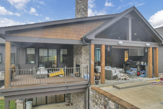 rear view of property with an outdoor hangout area and a patio