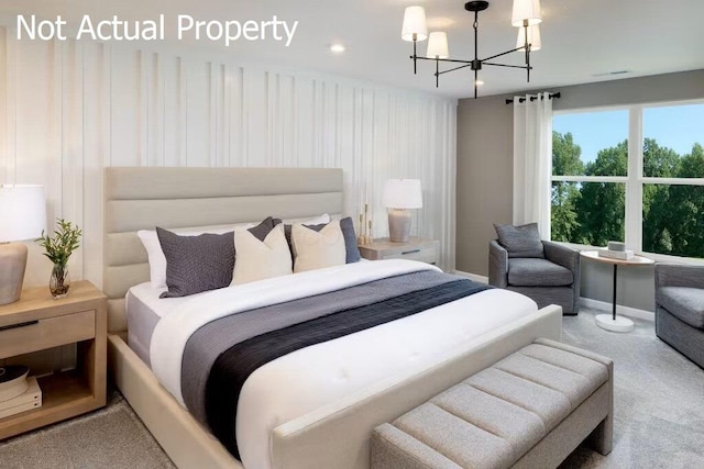 carpeted bedroom with an inviting chandelier