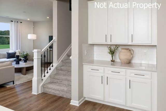 stairs featuring hardwood / wood-style floors