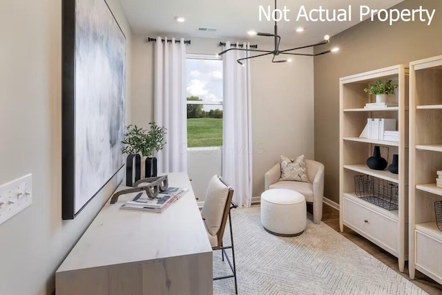 office space with hardwood / wood-style flooring and an inviting chandelier