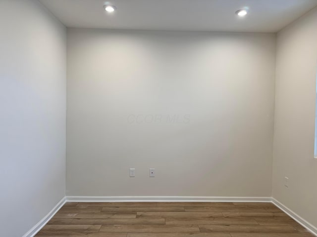 empty room with wood-type flooring