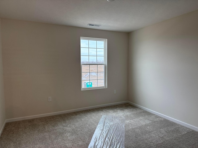 unfurnished room featuring carpet