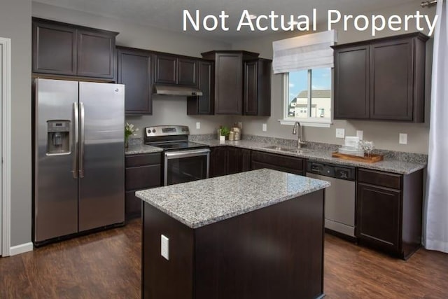 kitchen with dark brown cabinetry, sink, stainless steel appliances, dark hardwood / wood-style flooring, and a kitchen island