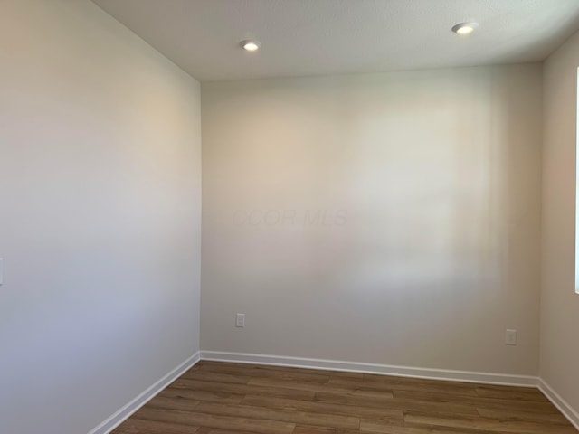 empty room featuring dark hardwood / wood-style flooring