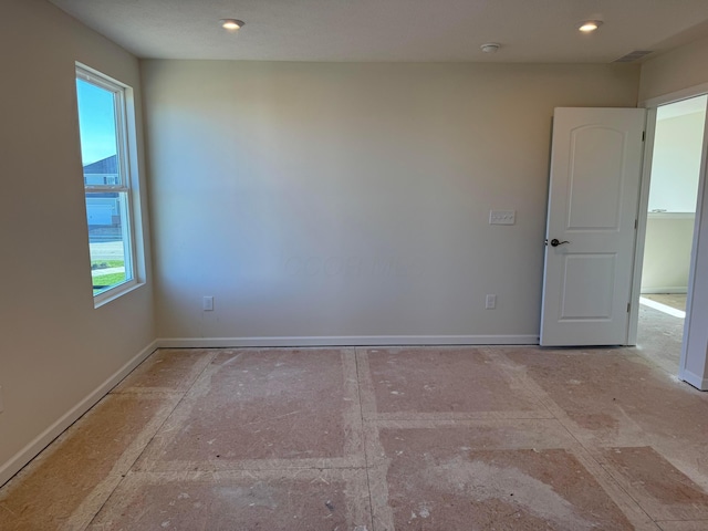 unfurnished room featuring plenty of natural light