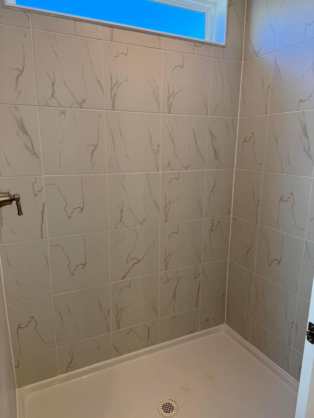 bathroom with tiled shower