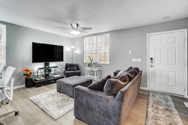 living room featuring hardwood / wood-style floors and ceiling fan