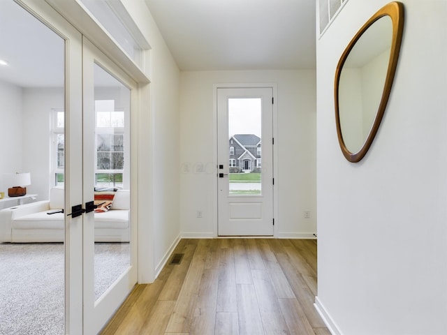 doorway featuring french doors and light hardwood / wood-style flooring