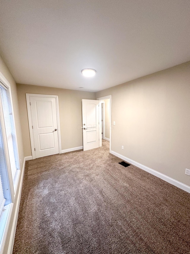 unfurnished bedroom featuring carpet