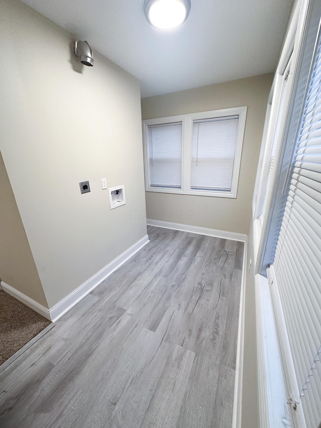 laundry room with electric dryer hookup, hookup for a washing machine, and light hardwood / wood-style floors