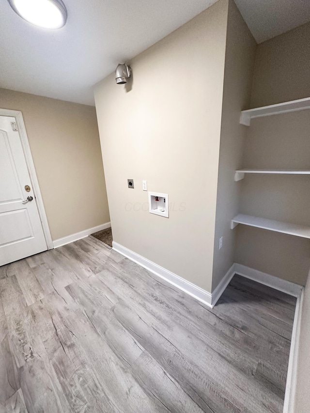 laundry room featuring hookup for an electric dryer, washer hookup, and light hardwood / wood-style flooring