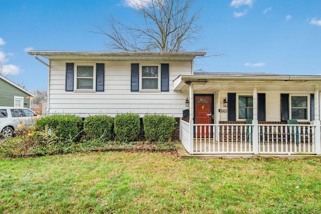 split level home featuring covered porch and a front lawn