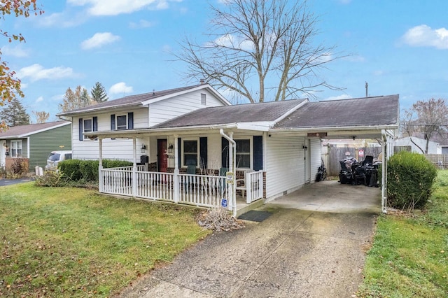 view of front of property with a carport, a porch, and a front yard