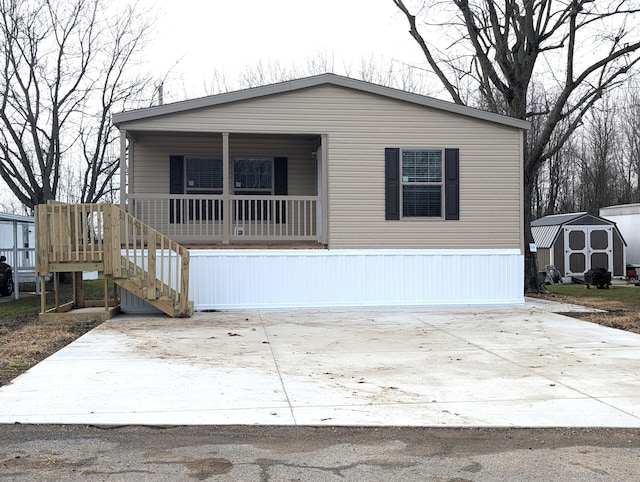 manufactured / mobile home with a porch and a storage unit