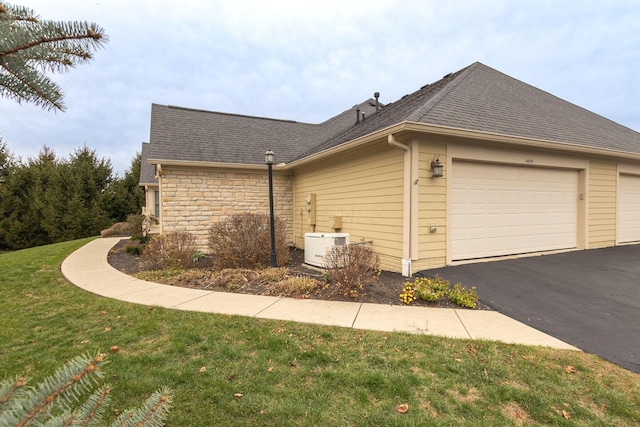 view of home's exterior featuring a lawn and a garage