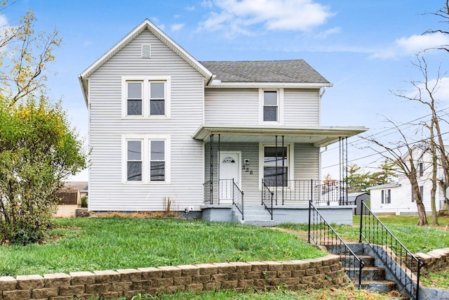 view of front of home featuring a front lawn and covered porch