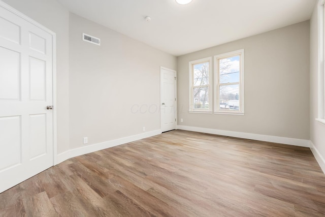 unfurnished room with light hardwood / wood-style floors