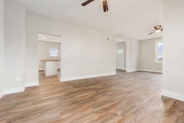 unfurnished room featuring ceiling fan and light hardwood / wood-style floors