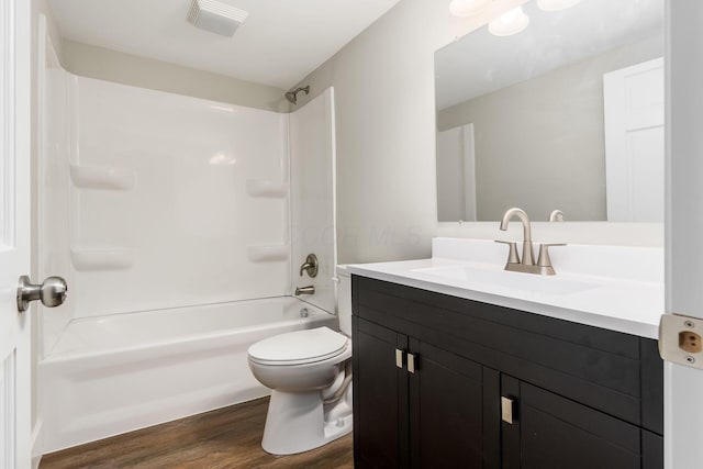 full bathroom with vanity, wood-type flooring, shower / bathtub combination, and toilet