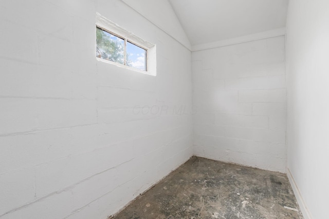 unfurnished room featuring lofted ceiling