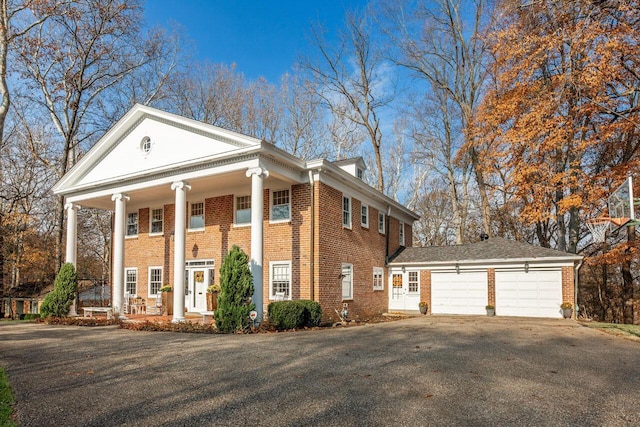 neoclassical / greek revival house with covered porch and a garage